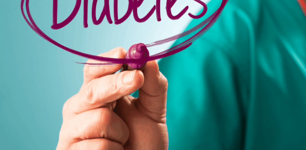 Doctor writing the word Diabetes in purple marker on glass screen