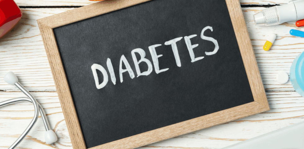 Chalkboard with the word Diabetes surrounded by stethoscope and medical supplies