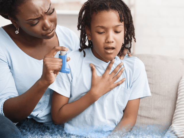Mother holding an inhaler while comforting her child having trouble breathing, with text Asthma Awareness Month