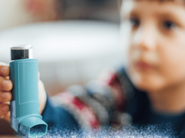 Child holding asthma inhaler for Asthma Awareness Month