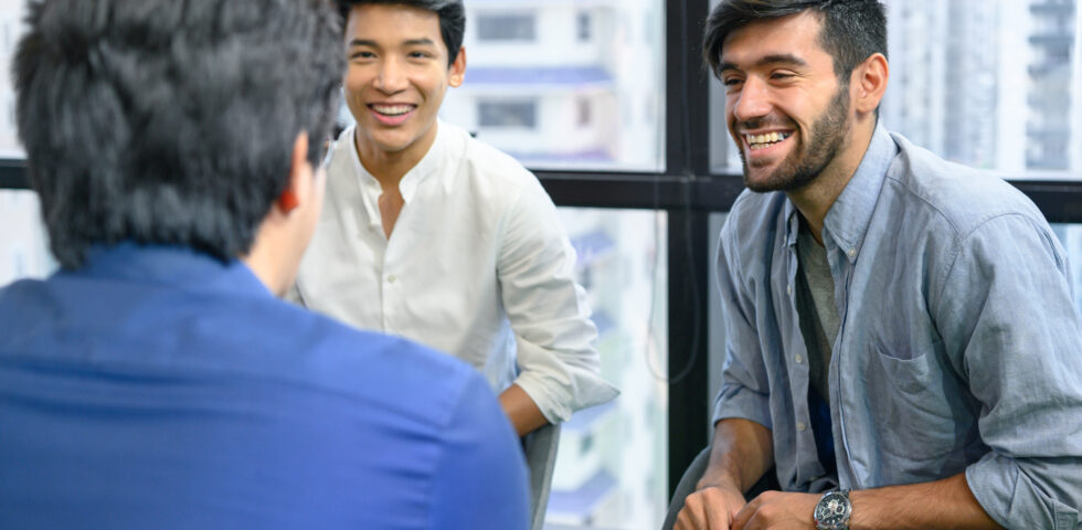 Group of men sitting together and smiling during a discussion